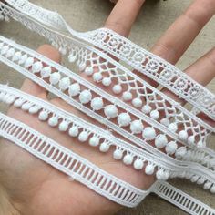 the hand is covered with white lace and has two fingers on each side of it