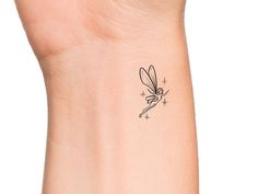 a small tattoo on the wrist of a woman