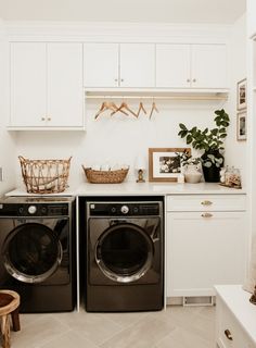 a washer and dryer in a white laundry room