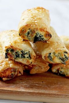 some food is stacked on top of each other with cheese and spinach in the middle