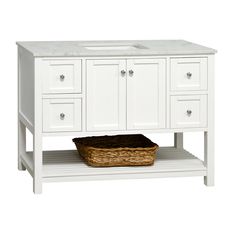 a white bathroom vanity with two sinks and a basket