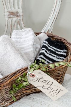 a wicker basket filled with towels and a tag that says stay dry on it