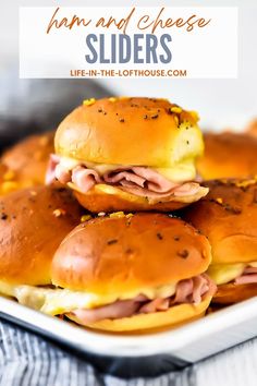 ham and cheese sliders stacked on top of each other in a white plate with text overlay