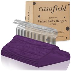 a blue comb sitting on top of a box next to it's cardboard packaging