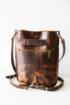 Waxed Leather Satchel Backpack, Leather Bucket Bag With Removable Pouch For Travel, Leather Satchel Backpack With Leather Lining For Everyday, Everyday Carry Leather Satchel Backpack With Leather Lining, Leather Shoulder Bag With Standard Backpack Shape, Leather Crossbody Backpack For Everyday, Brown Leather Bucket Backpack With Removable Pouch, Brown Bucket Leather Backpack With Removable Pouch, Waxed Leather Satchel Backpack For Daily Use