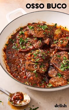 a pot filled with meat and sauce on top of a table