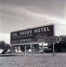 a large sign in front of a motel