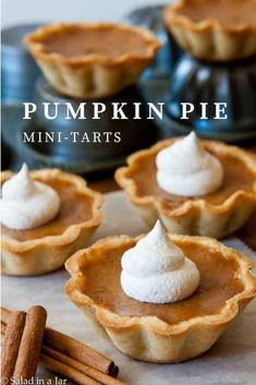 mini pies with whipped cream on top sitting on a paper towel in front of an old fashioned baking tin