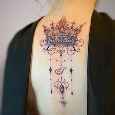 a woman with a crown tattoo on her shoulder