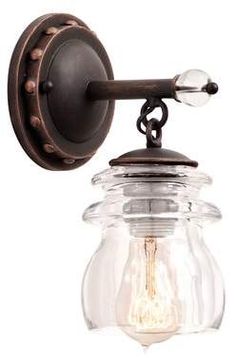 an old fashioned wall light with a clear glass jar hanging from it's side