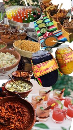 many different types of food and drinks on a table with flowers in vases next to each other