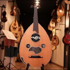 a wooden instrument with an image of a man's face on the top of it