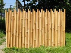 a tall wooden fence sitting in the grass