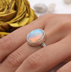 Ethiopian Opal Ring - 925 Sterling Silver Ring - Handmade Ring - Hippie Ring - Minimalist Gemstone Jewellery - Ring For Women   Gemstone Name - Ethiopian Opal Gemstone . Stone Quality - AAA. Ring Weight - 3.21 g  Length  - 1.4 cm Width -  1.1 cm Stone Shape - as Shown In The Picture. Ring Size - All Ring Size Available .  All Our Jewelry is Stamped 925  We serve complete 925 sterling silver Jewelry and genuine properties of the stone, Our all products are stamped 925. Product Quality and Packaging - Our all products are 925 Silver Stamped which shows that the product is genuine and authentic .The products are dispatched from the small business from UK so you get the product on time and the product packaging comes in bubble foil wrap with all the precautions taken primarily that your produc Iridescent Gemstone Jewelry, Iridescent Round Gemstone Jewelry, Iridescent Round Sterling Silver Jewelry, Iridescent Sterling Silver Round Jewelry, Adjustable Midi Rings With Bezel Setting, Adjustable Round Midi Rings With Bezel Setting, Silver Minimalist Opal Rings, Minimalist Opal Ring With Bezel Setting, Sterling Silver Opal Ring With Polished Finish