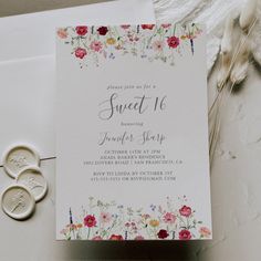 wedding stationery with flowers and two rings