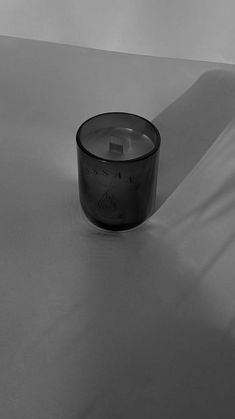 a glass candle sitting on top of a table