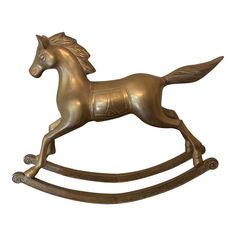 a bronze rocking horse on a white background