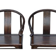 two wooden chairs sitting side by side on top of each other, one with curved arms and the other with bent legs