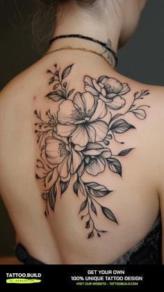 the back of a woman's shoulder with flowers on it