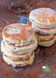 three pancakes stacked on top of each other with powdered sugar and jelly toppings