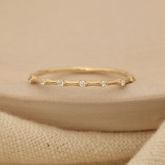 a gold ring with three diamonds on it