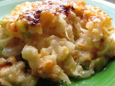 a green plate topped with macaroni and cheese