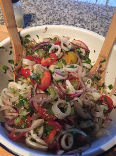 a white bowl filled with lots of veggies