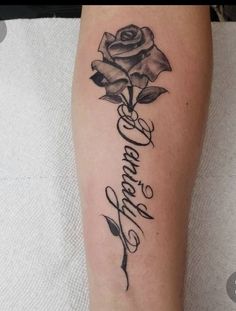 a rose tattoo on the arm that says love