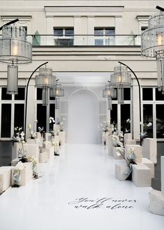 the entrance to an elegant wedding venue with white flowers and candles