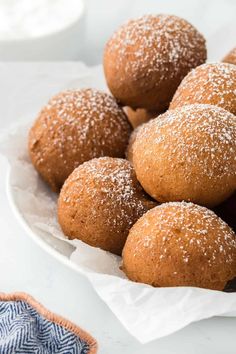 a white plate topped with sugar covered donuts