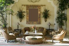 a living room filled with furniture and potted plants