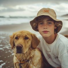 a boy and his dog on the beach