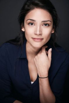 a woman posing for a photo with her hand on her chin