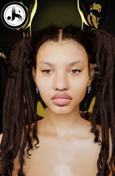 a woman with long dreadlocks on her head