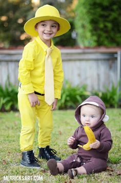 two young children dressed in yellow and wearing matching outfits, one is holding a banana