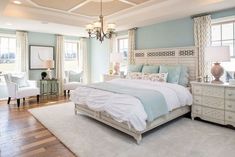 a bedroom with blue walls and white furniture