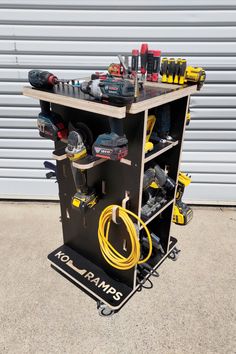 a work bench with tools on it in front of a garage door