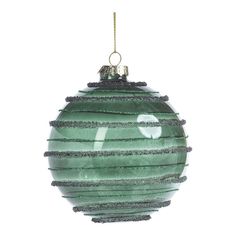 a green glass ornament hanging from a gold chain