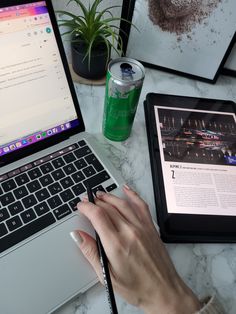 a person using a laptop computer on a marble table