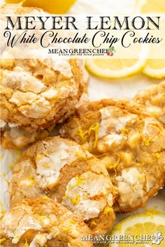 lemon white chocolate chip cookies on a plate with sliced lemons and one cookie in the background