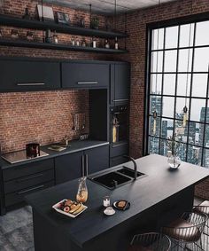 an industrial kitchen with black cabinets and counter tops, along with a large window that looks out onto the city