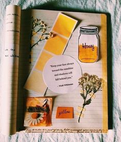 an open notebook with flowers and writing on it, next to a jar of honey