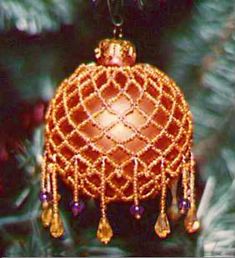 an ornament hanging from a christmas tree in the shape of a ball with tassels