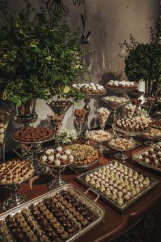 a table topped with lots of different types of desserts