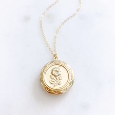 "DESCRIPTION: The CAMELLIA Necklace - Gold Round Floral Locket on a dainty gold filled chain. We love this sweet little necklace and think you will too! Insert a treasured photo and keep it close to your heart! The cutest way to show your love for someone special! MATERIALS: Chain, Clasp, Jump Rings - Gold Filled Locket - Gold Plated PENDANT SIZE: Approximately 3/4\" in diameter PACKAGING: Your necklace will arrive on a Dainty Doe signature jewelry card placed in a white jewelry box, with a bow Gift For Mom From Daughter, Herkimer Diamond Necklace, Silver Jewelry Cleaner, Necklace Locket, Star And Moon Necklace, Gold Locket Necklace, White Jewelry Box, Christmas Gift For Mom, Round Rock