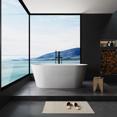 a bathroom with a large window and a white bathtub in the middle of it