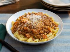 a white bowl filled with pasta and meat sauce