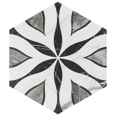 a black and white hexagonal tile with an abstract design on it's surface