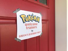 a red door with a sign on it that says welcome trainers to gaun's birthday party