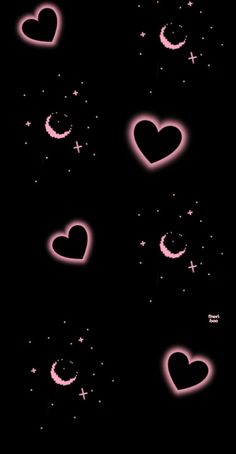 some pink hearts are flying in the air with stars and crescents above them on a black background